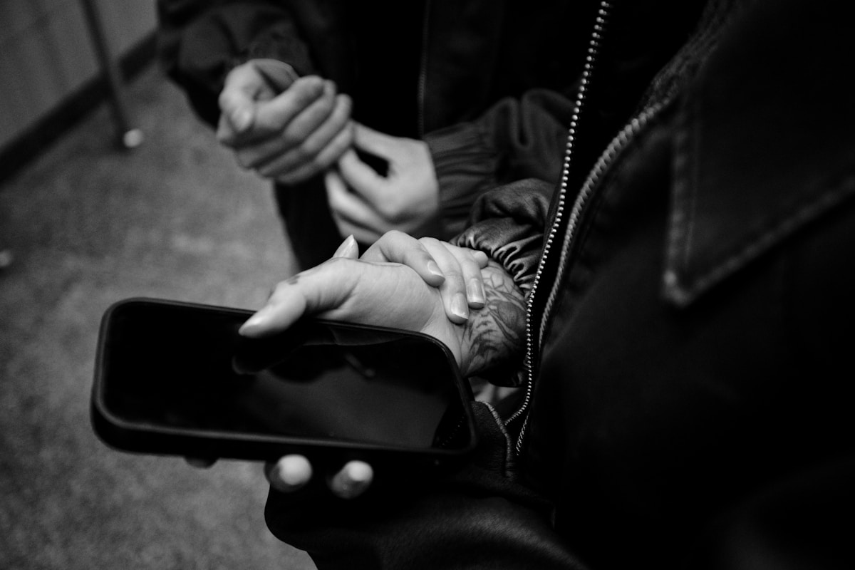 Two people connecting while holding a mobile phone