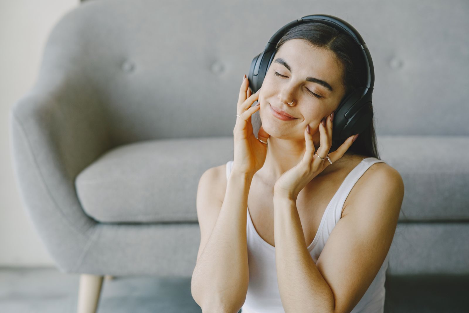 Person relaxing with wireless headphones during a guided audio session