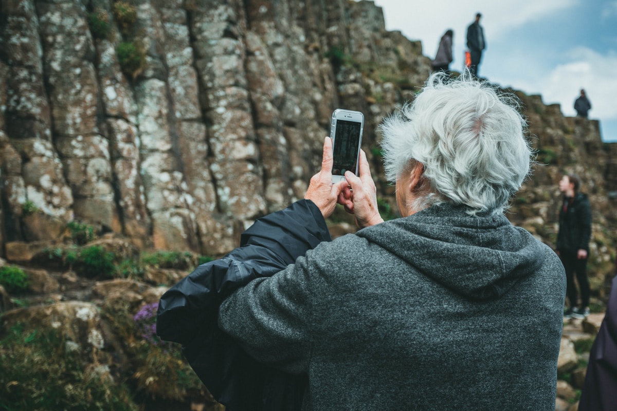 Older adult using a mobile phone outdoors