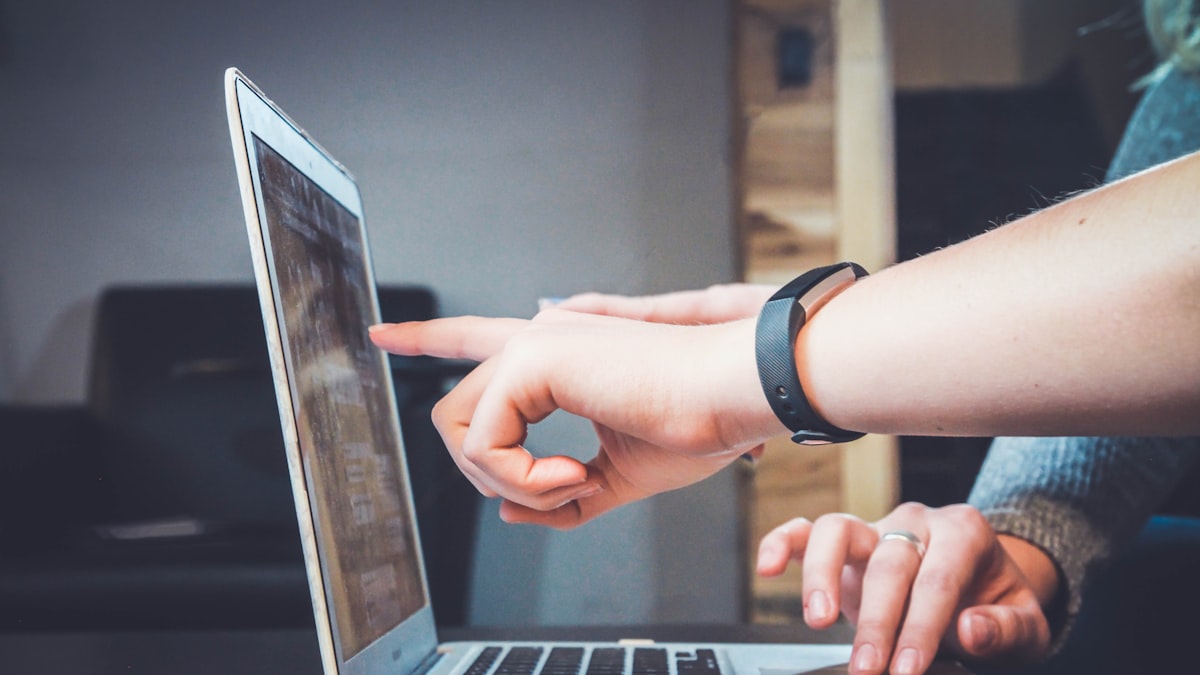 Hands pointing at a tablet screen while reviewing results together