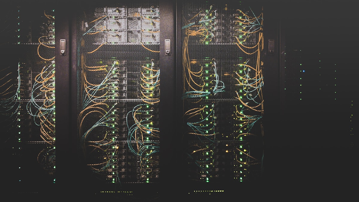Rows of server racks with patch cabling running between them